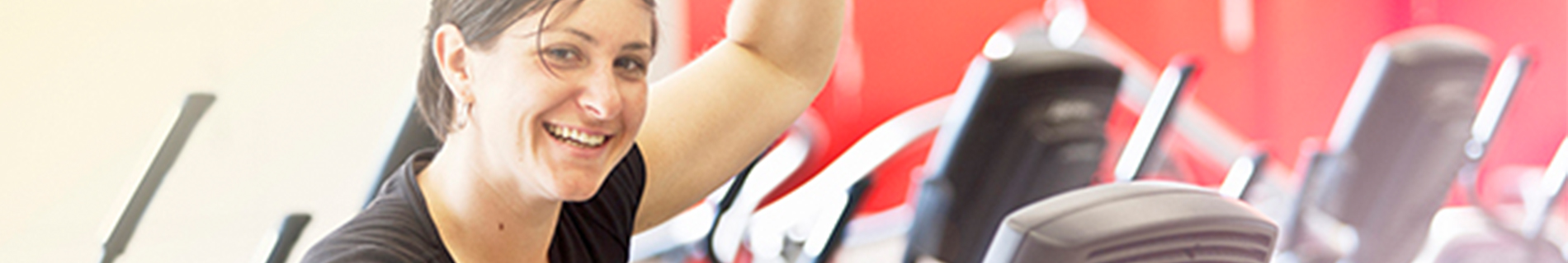 Woman on workout machine at gym.